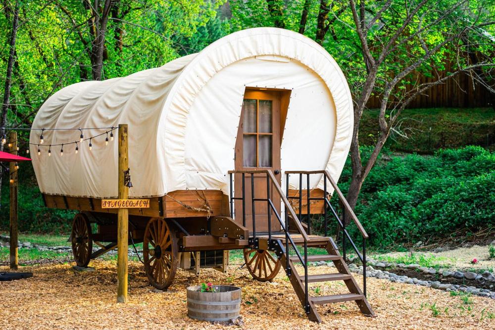 Cozy Wild West Covered Wagon next to River